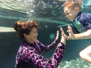 Learning to open your eyes under the water during swim lessons.
