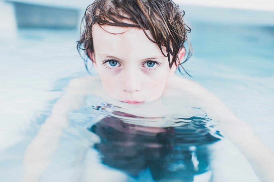 Child hanging out in the swimming pool.