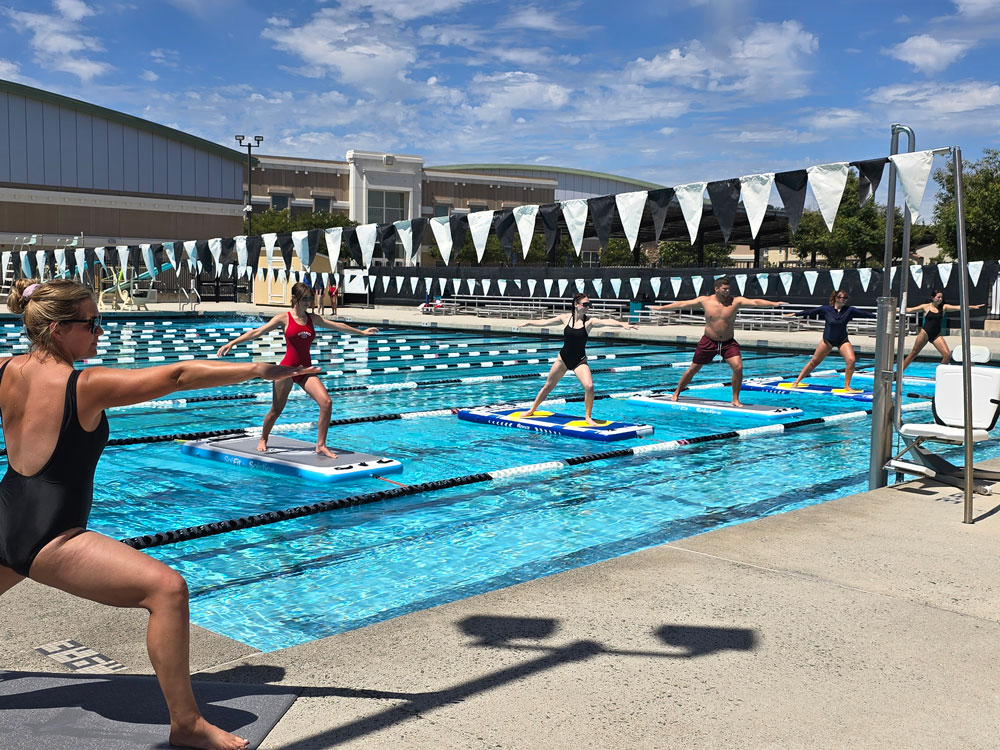 SUP Yoga class in session in the pool at Gilroy CHS Aquatic Center in Gilroy, CA 